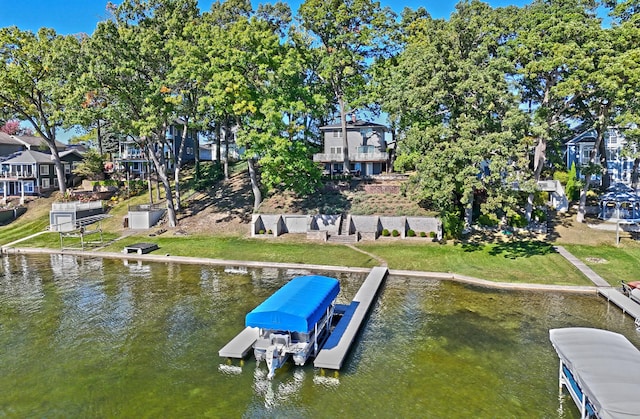 dock area featuring a water view and a yard