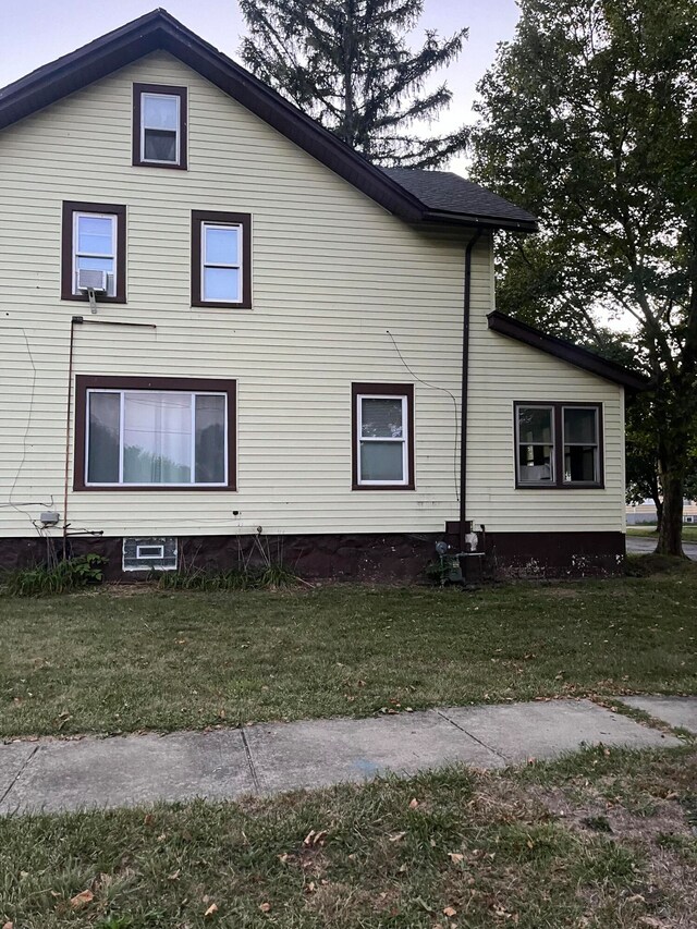 view of home's exterior with a yard