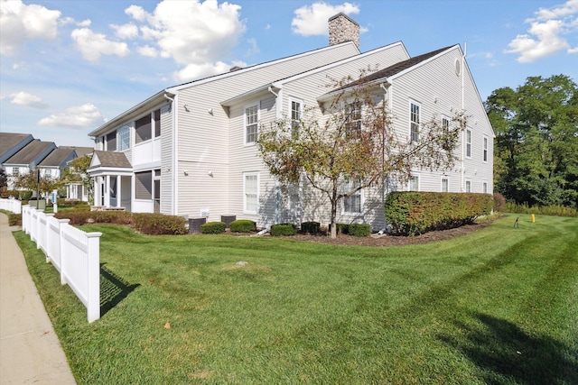 view of side of property with a yard