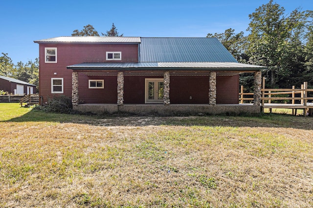 rear view of property with a lawn