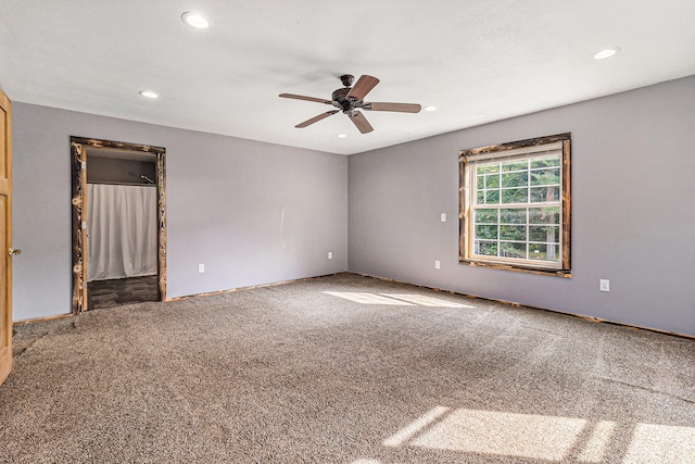 empty room with carpet flooring and ceiling fan