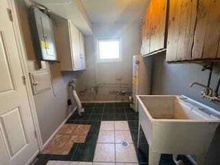 clothes washing area with tile patterned floors and sink