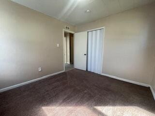 unfurnished bedroom with a closet and carpet floors