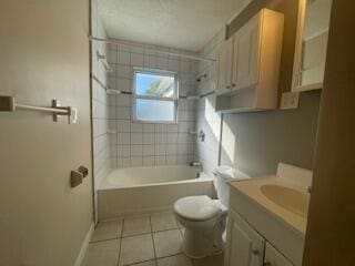 full bathroom with vanity, toilet, tile patterned floors, and tiled shower / bath combo