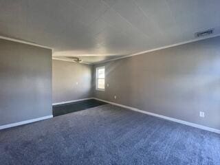 spare room with dark carpet