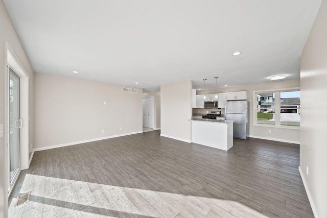 unfurnished living room with dark hardwood / wood-style flooring