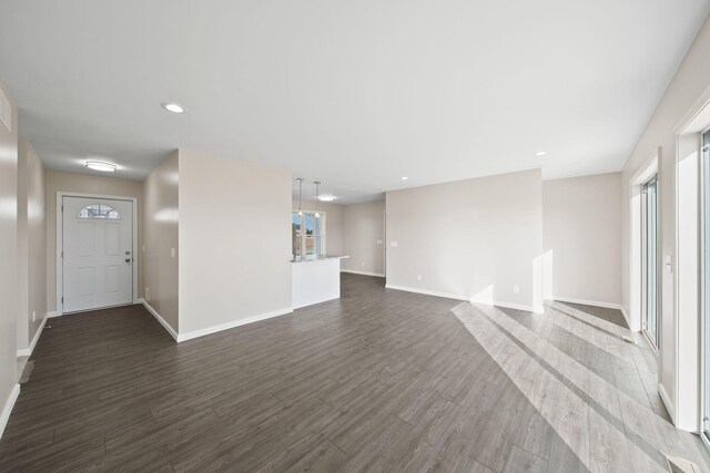 unfurnished living room with dark hardwood / wood-style flooring