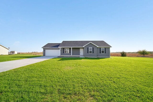 ranch-style house with a garage and a front lawn