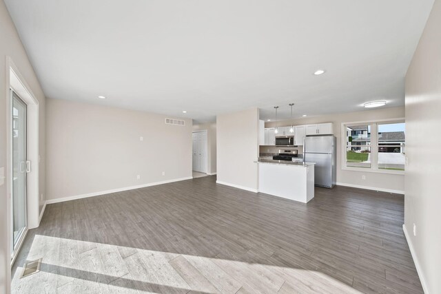 unfurnished living room with dark wood-type flooring