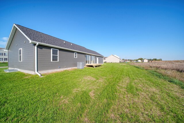 back of house featuring cooling unit and a yard