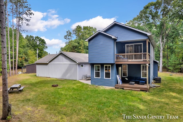 rear view of house with cooling unit, a deck, and a yard