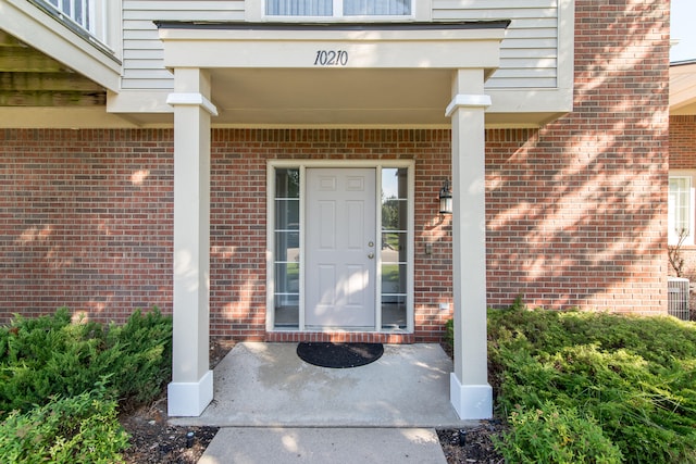 view of exterior entry featuring covered porch