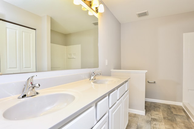 bathroom featuring hardwood / wood-style flooring and vanity