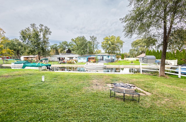 view of yard with a fire pit and a water view