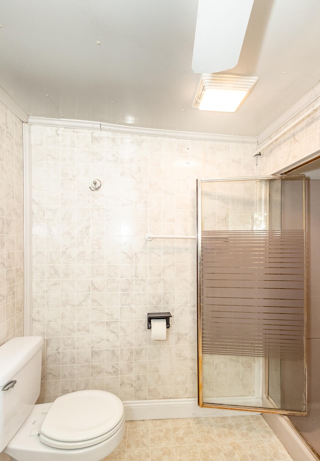 bathroom with walk in shower, tile walls, toilet, and tile patterned floors