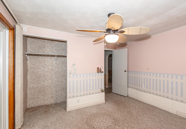 unfurnished bedroom featuring ceiling fan, carpet floors, and a closet