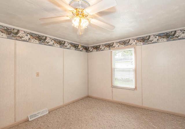 empty room with ceiling fan and carpet