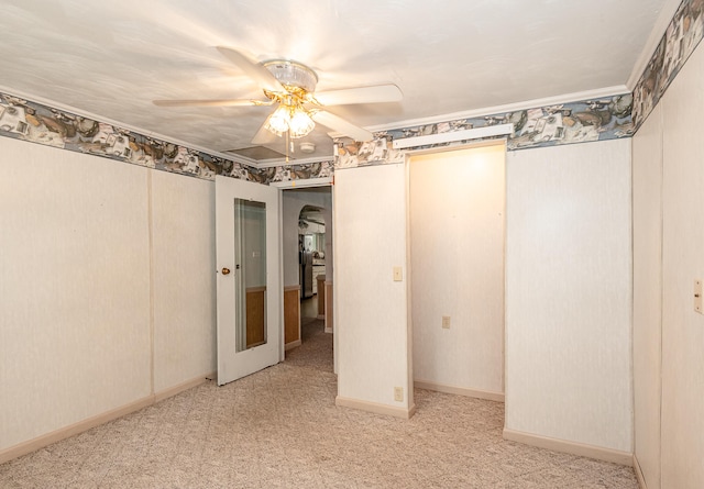 carpeted empty room featuring ceiling fan