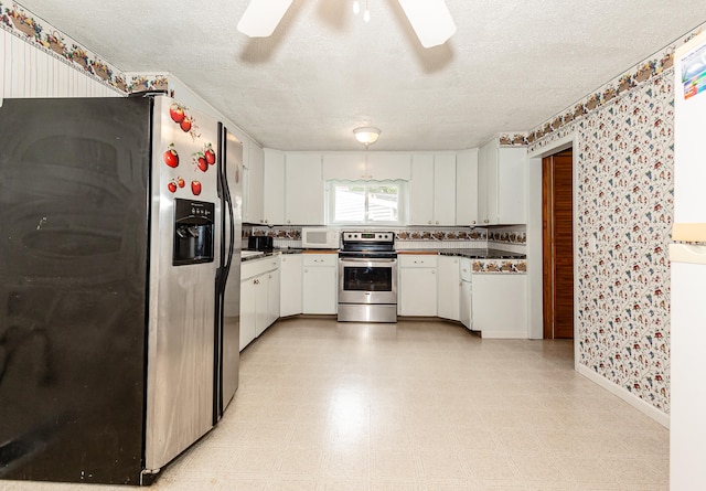 kitchen with ceiling fan, white cabinets, a textured ceiling, and appliances with stainless steel finishes