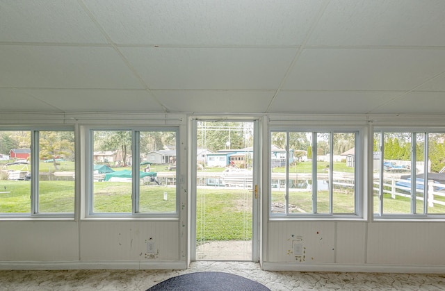 unfurnished sunroom with a drop ceiling