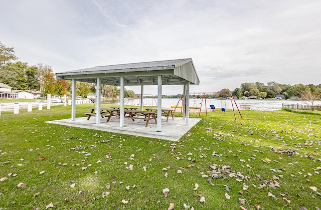 view of yard with a playground, a gazebo, and a water view