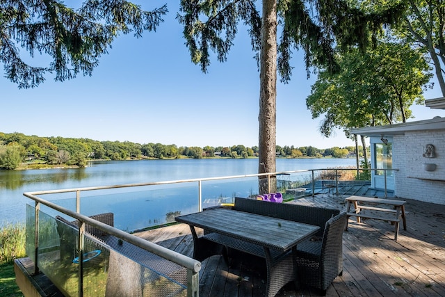 exterior space featuring a deck with water view