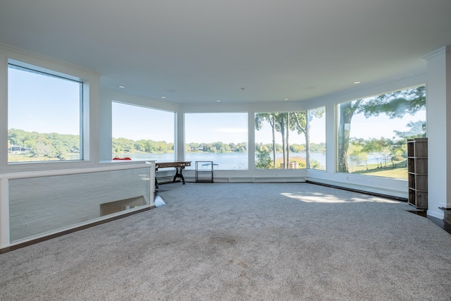 unfurnished sunroom with a water view