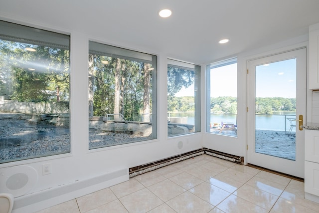 unfurnished sunroom featuring a water view