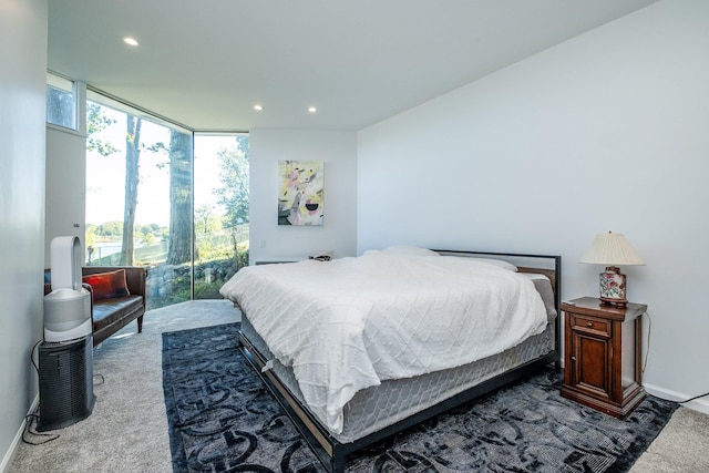 bedroom featuring a wall of windows and carpet