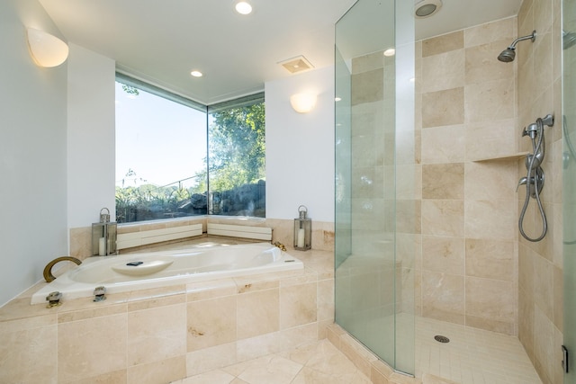 bathroom with shower with separate bathtub and tile patterned flooring