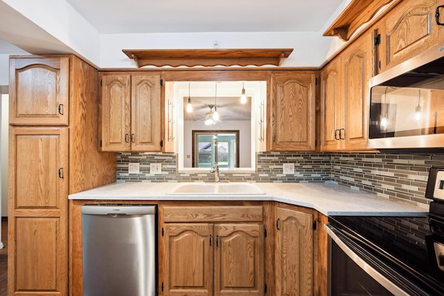 kitchen featuring ceiling fan, sink, stainless steel appliances, and tasteful backsplash