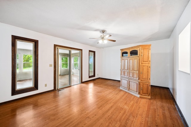 empty room featuring light hardwood / wood-style floors and ceiling fan