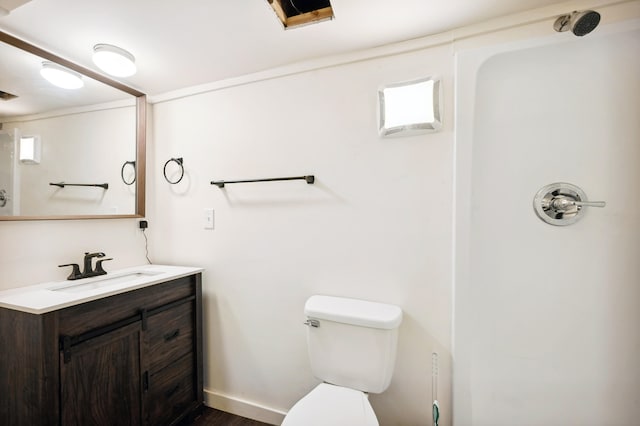 bathroom featuring wood-type flooring, vanity, and toilet