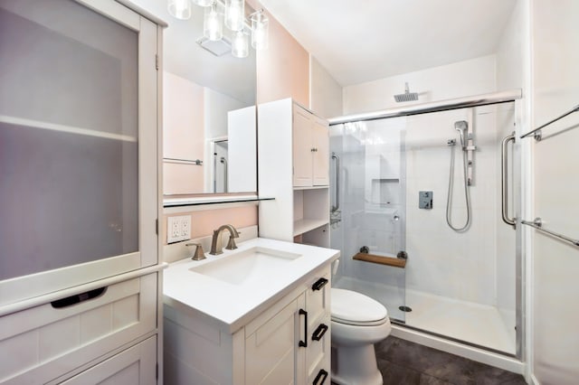 bathroom featuring vanity, tile patterned flooring, toilet, and an enclosed shower