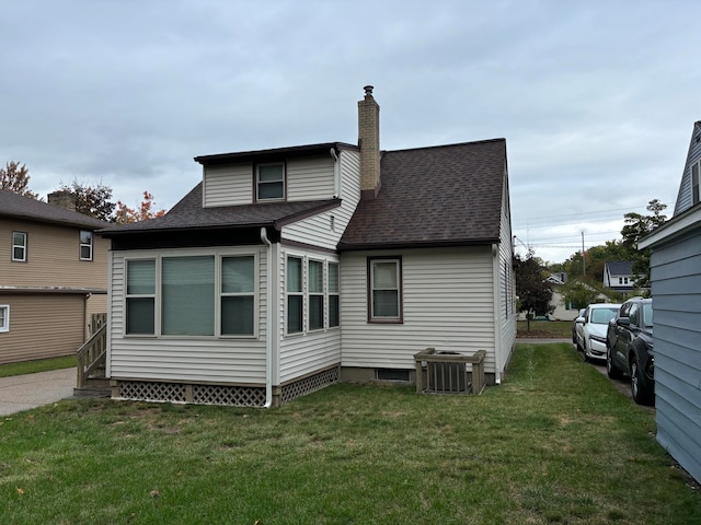 rear view of house featuring a lawn