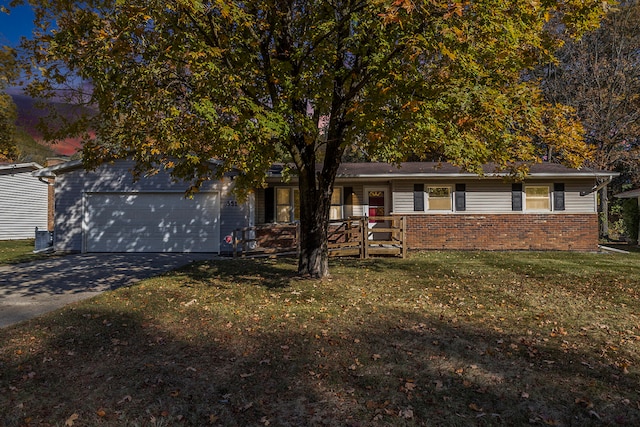 view of front of house with a front yard and a garage