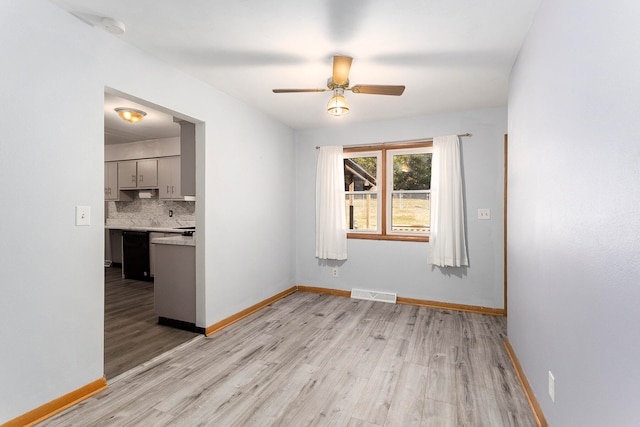 spare room featuring light wood-type flooring and ceiling fan