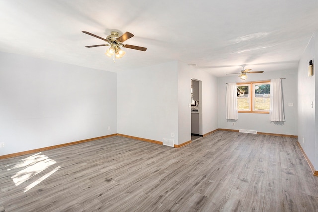 unfurnished room with light wood-type flooring and ceiling fan