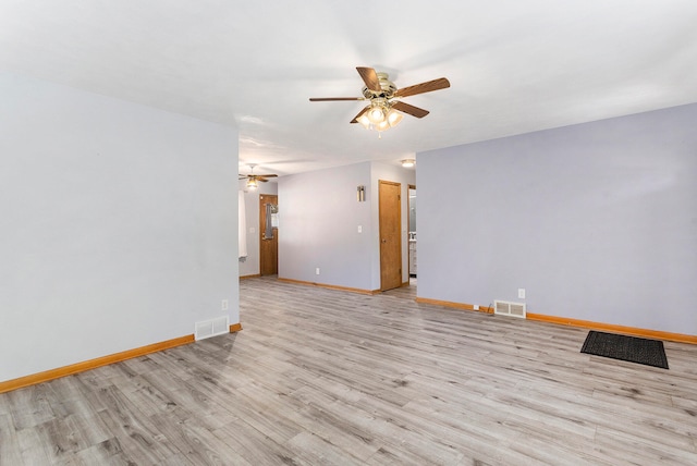 empty room with ceiling fan and light hardwood / wood-style flooring