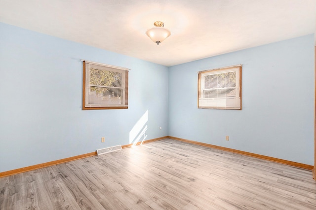 empty room with light hardwood / wood-style flooring