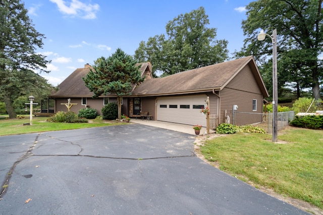 view of front of home with a front lawn and a garage