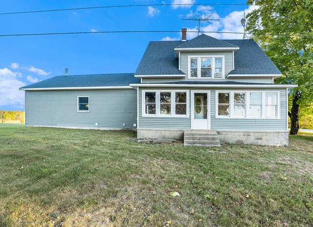 rear view of house with a yard