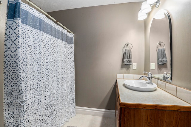 bathroom featuring vanity and curtained shower