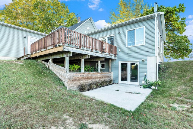 back of house with a deck, a yard, and a patio area