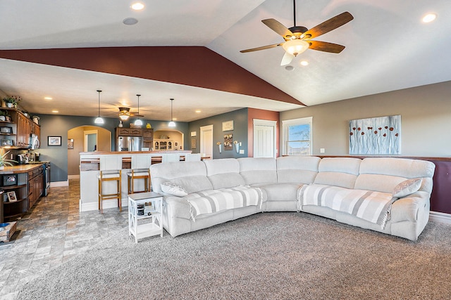 carpeted living room with lofted ceiling and ceiling fan