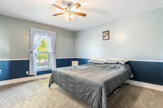 carpeted bedroom with ceiling fan and a textured ceiling