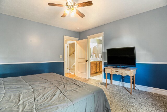 carpeted bedroom featuring connected bathroom and ceiling fan