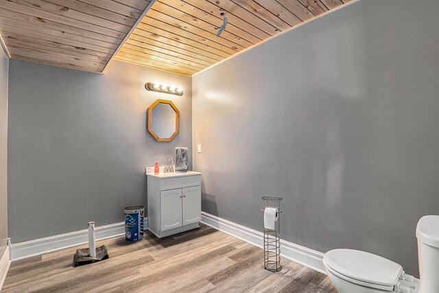 bathroom featuring wooden ceiling, vanity, toilet, and hardwood / wood-style flooring