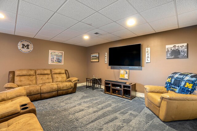 living room with a paneled ceiling and carpet flooring