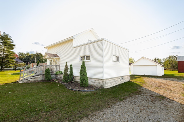 view of property exterior featuring a lawn, an outdoor structure, and a garage